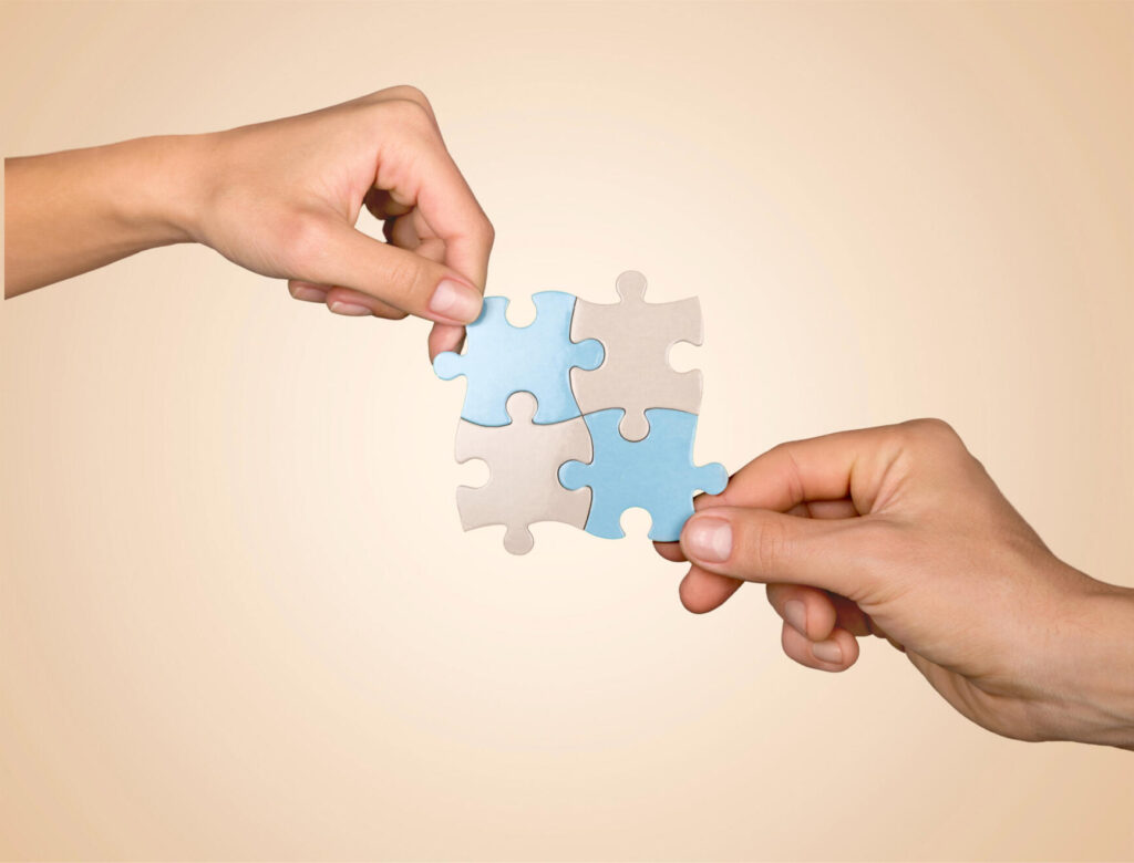 a close-up of hands holding a puzzle