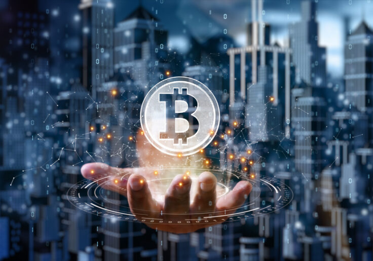 Outstretched hand with bitcoin symbol hovering above it.