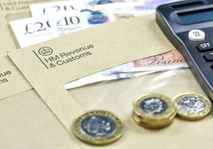 England, UK - August 16 2018: The logo of Her Majesty Revenue and Customs on envelope, with money or check included inside.  HMRC is a non-ministerial dept of the UK Government. Editorial photo.