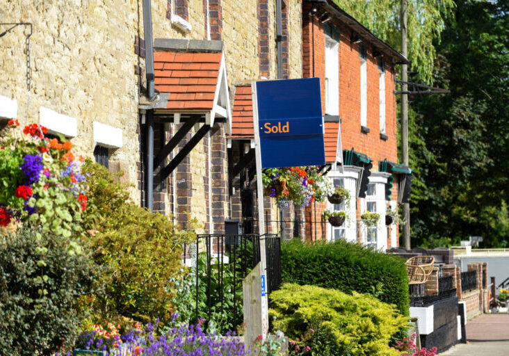 House for sale sign reading sold by estate agent or real estate letting